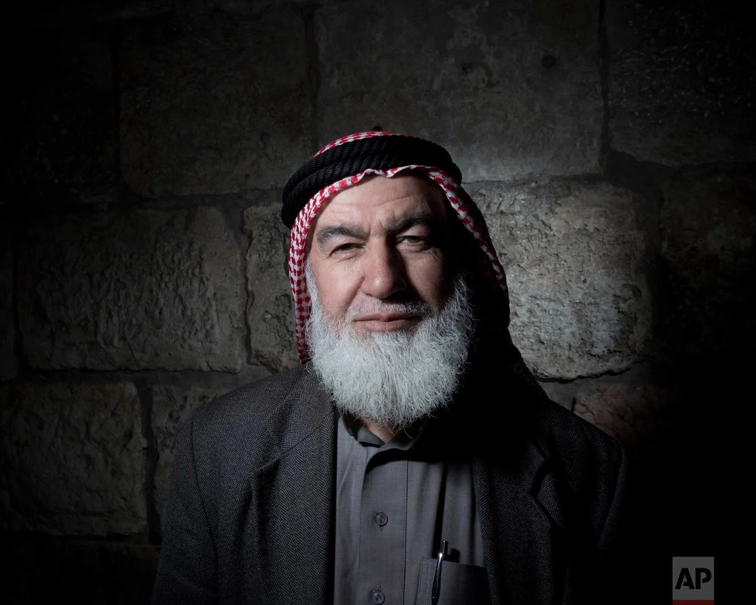In this Sunday, Feb. 11, 2018 photo, Ebrahim Hamada poses for a portrait in Jerusalem's Old City. (AP Photo/Oded Balilty)