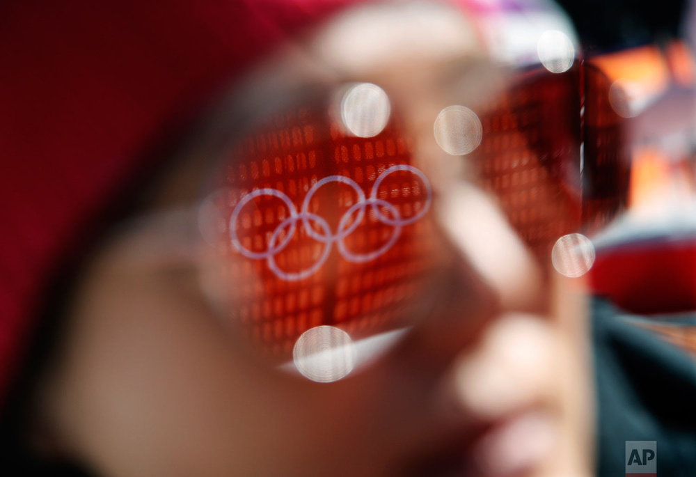  The Olympic rings are reflected in the sunglasses of a spectator before the start of the women's super-G at the 2018 Winter Olympics in Jeongseon, South Korea, Saturday, Feb. 17, 2018. (AP Photo/Christophe Ena) 