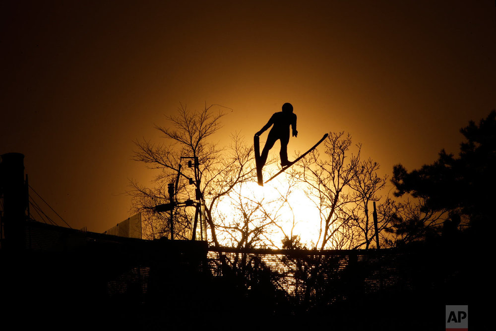  Laurent Muhlethaler, of France, is silhouetted as he jumps during training for the nordic combined competition at the 2018 Winter Olympics in Pyeongchang, South Korea, Sunday, Feb. 18, 2018. (AP Photo/Dmitri Lovetsky) 
