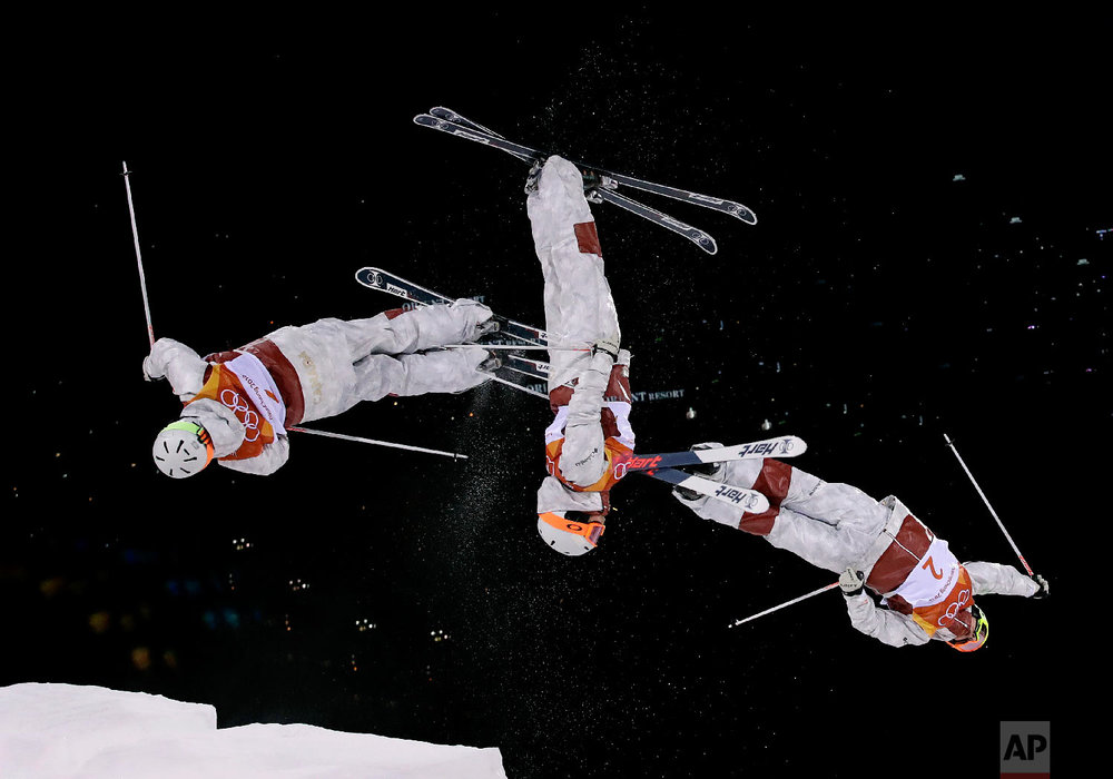  In this multiple exposure photo, Andi Naude, of Canada, jumps during the women's moguls finals at Phoenix Snow Park at the 2018 Winter Olympics in Pyeongchang, South Korea, Sunday, Feb. 11, 2018. (AP Photo/Gregory Bull) 