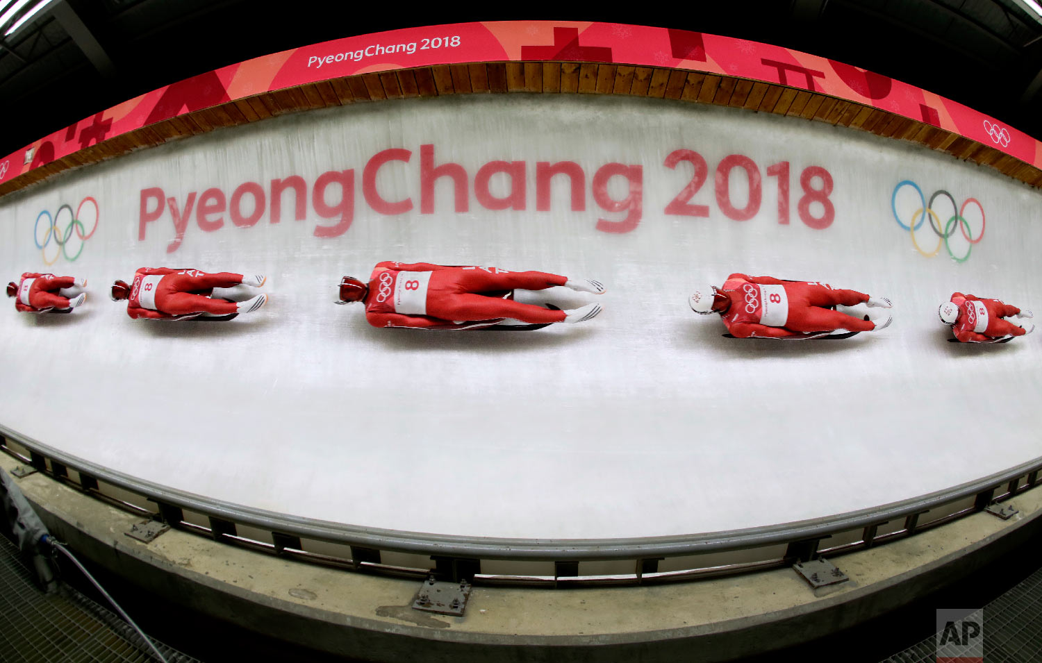  In this multiple exposure photo, Kristers Aparjods, of Latvia, makes his third run during final heats of the men's luge competition the 2018 Winter Olympics in Pyeongchang, South Korea, Sunday, Feb. 11, 2018. (AP Photo/Charlie Riedel) 