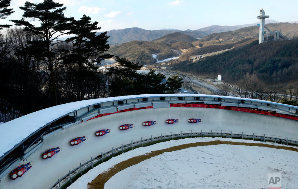  In this multiple exposure photo, Marek Solcansky and Karol Stuchlak, of Slovakia, take a practice run during the men's doubles luge training at the 2018 Winter Olympics in Pyeongchang, South Korea, Monday, Feb. 12, 2018. (AP Photo/Charlie Riedel) 