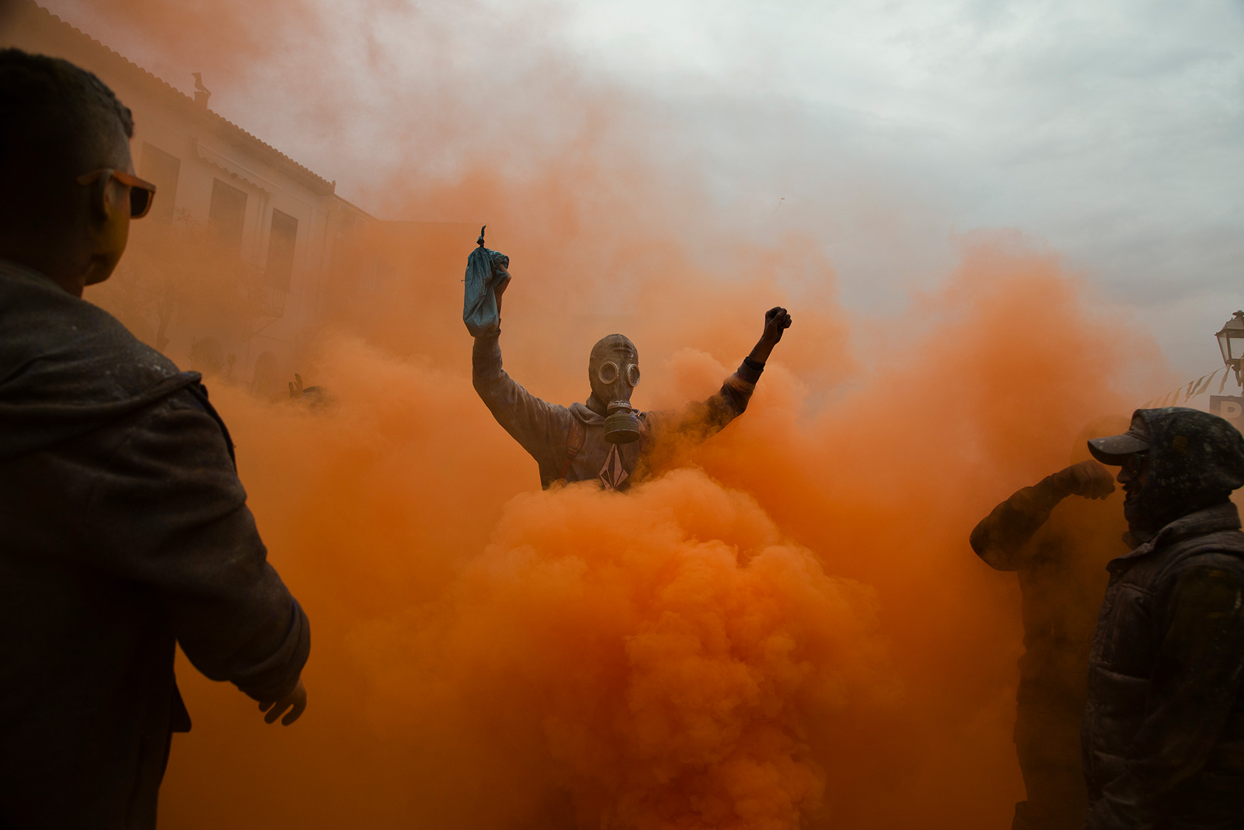  in this Monday, Feb. 19, 2018 photo, revelers take part in the flour war, a unique colorful flour fight marking the end of the carnival season in the port town of Galaxidi, some 200 kilometers (120 miles) west of Athens.  (AP Photo/Petros Giannakour