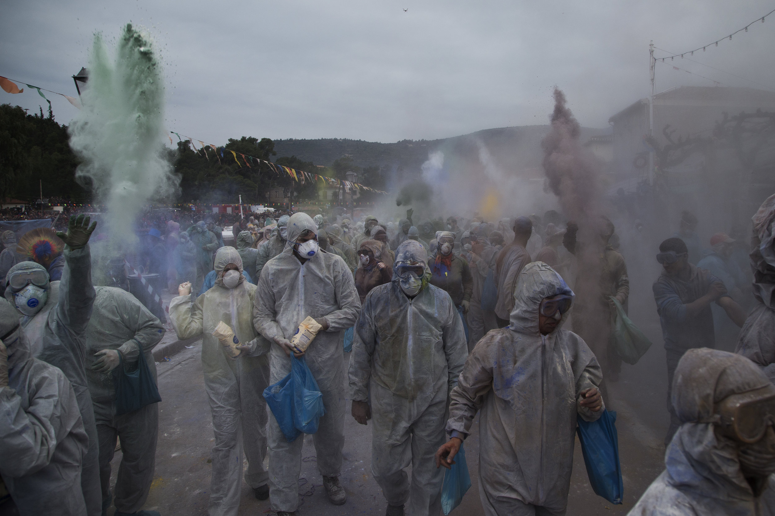  In this Monday, Feb. 19, 2018 photo, revelers throw flour as they take part in the flour war, a unique colorful flour fight marking the end of the carnival season in the port town of Galaxidi, some 200 kilometers (120 miles) west of Athens.  (AP Pho