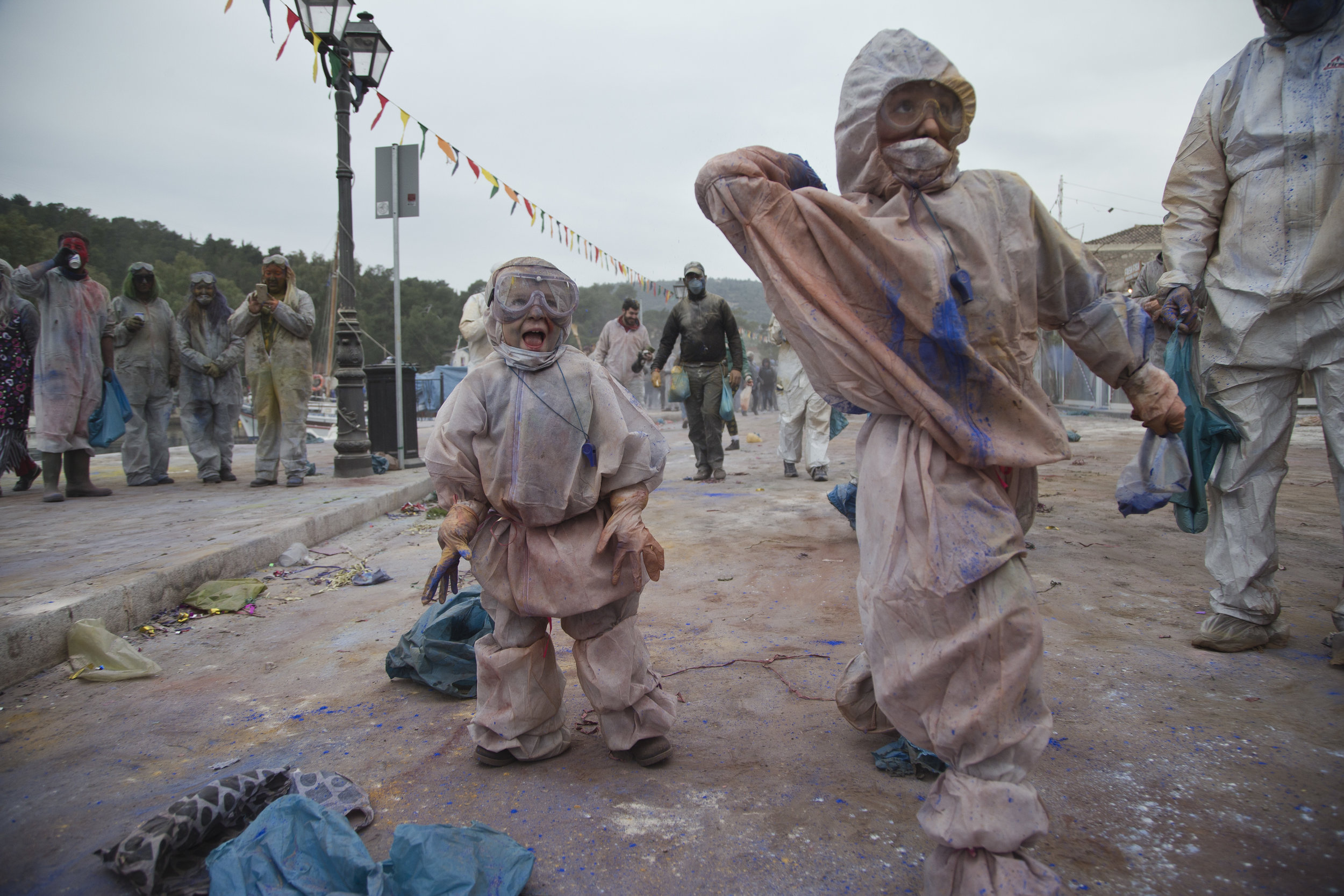  In this Monday, Feb. 19, 2018 photo, children throw flour as they take part in the flour war, a unique colorful flour fight marking the end of the carnival season in the port town of Galaxidi, some 200 kilometers (120 miles) west of Athens.  (AP Pho