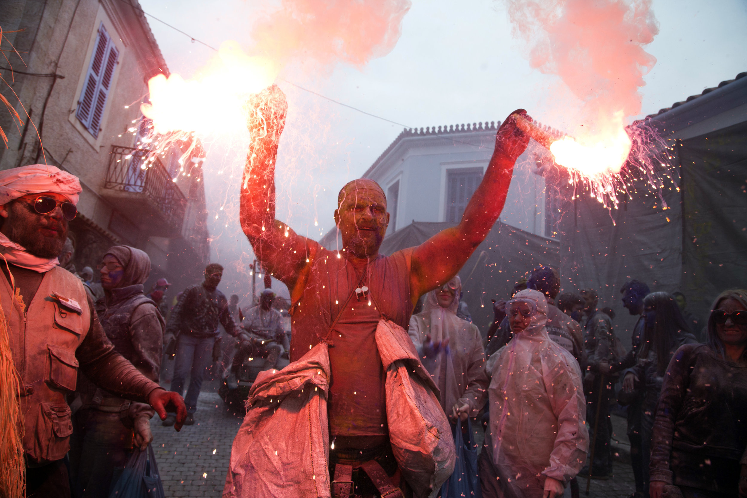  Revelers throw flour as they participate in the flour war, a unique colorful flour fight marking the end of the carnival season, in the port town of Galaxidi, some 200 kilometers (120 miles) west of Athens, Monday, Feb. 19, 2018. (AP Photo/Petros Gi