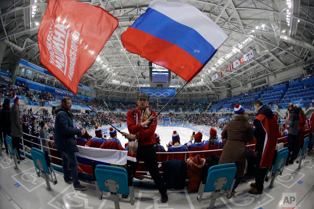  A fan of Russian athletes waves flags before the preliminary round of the men's hockey game between the team from Russia and the United States at the 2018 Winter Olympics in Gangneung, South Korea, Saturday, Feb. 17, 2018. (AP Photo/Julio Cortez) 