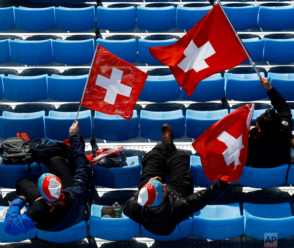  Fans wave Swiss flags as they watch the men's downhill at the 2018 Winter Olympics in Jeongseon, South Korea, Thursday, Feb. 15, 2018. (AP Photo/Charlie Riedel) 