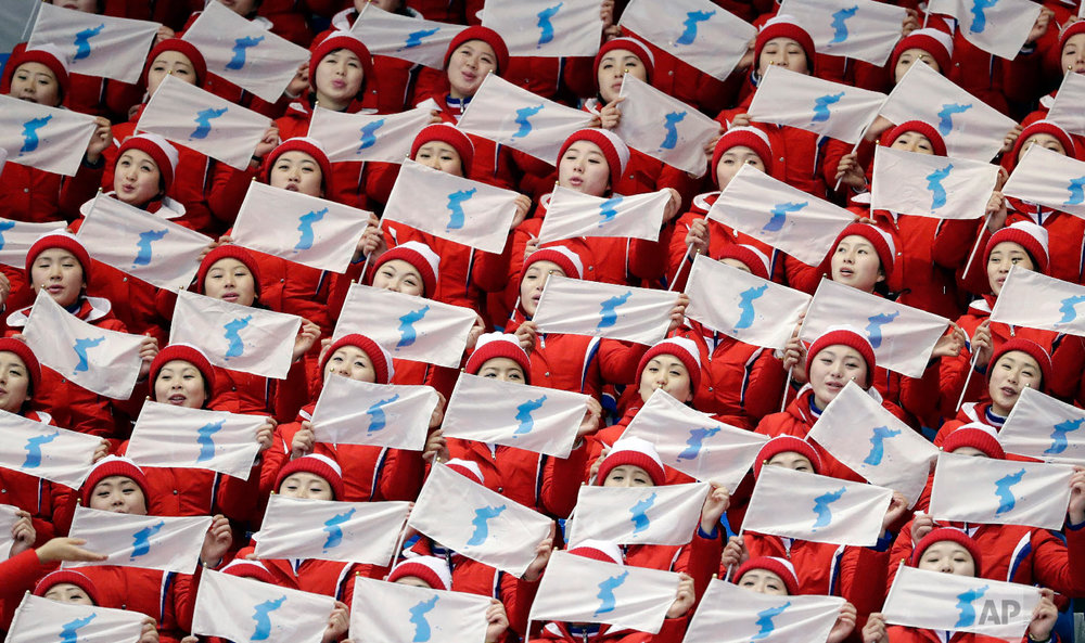  North Korea supporters sing and wave flags ahead of the pairs free skate figure skating final in the Gangneung Ice Arena at the 2018 Winter Olympics in Gangneung, South Korea, Thursday, Feb. 15, 2018. (AP Photo/Bernat Armangue) 