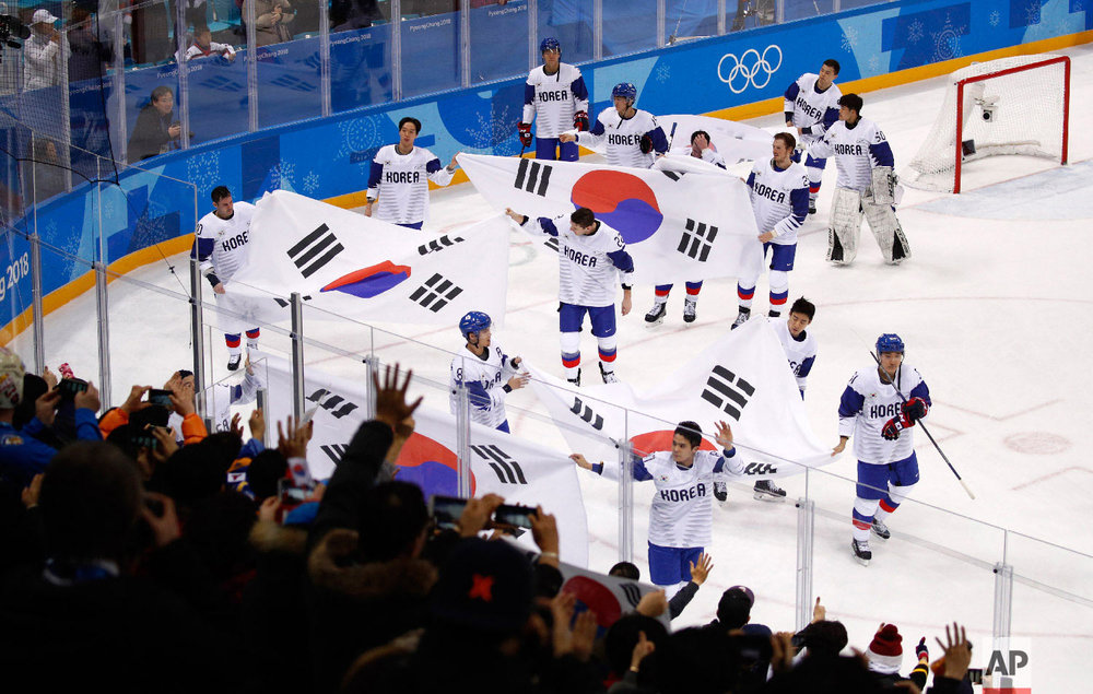  South Korea players wave flags as they skate around after the qualification round of the men's hockey game against Finland at the 2018 Winter Olympics in Gangneung, South Korea, Tuesday, Feb. 20, 2018. Finlandwon 5-2. (AP Photo/Jae C. Hong) 