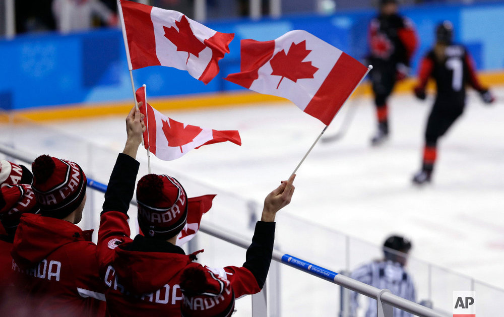  Fans wave flags during the third period of the preliminary round of the women's hockey game between Canada and Finland at the 2018 Winter Olympics in Gangneung, South Korea, Tuesday, Feb. 13, 2018. (AP Photo/Frank Franklin II) 