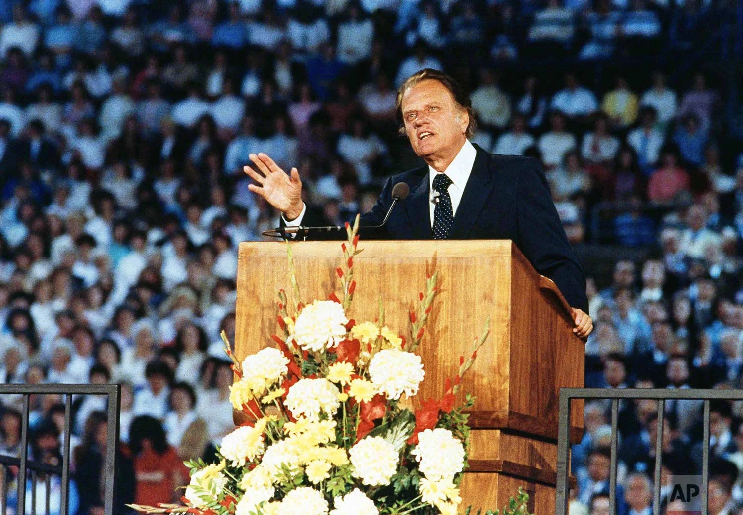 Rev. Billy Graham is shown preaching to 24,000 people in Tacoma’s New Dome Stadium, May 16, 1983, Tacoma, Wash. (AP Photo/Dave Ekren)