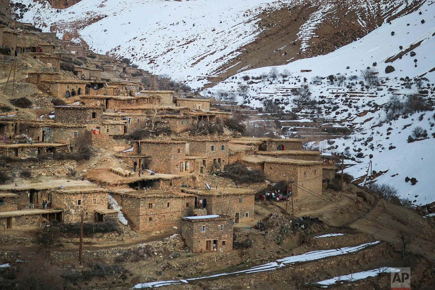 In this Wednesday, Feb. 14, 2018 photo, a Berber village, Tighanmin, is surrounded by snow covered mountains in the Middle Atlas, near Azilal, central Morocco. (AP Photo/Mosa'ab Elshamy)