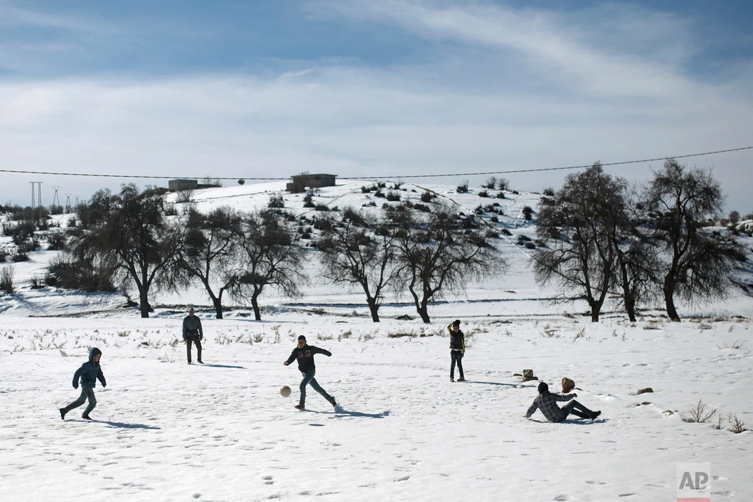 In this Thursday, Feb. 15, 2018, children play soccer in the snow in Tighanmin, a Middle Atlas village near Azilal, central Morocco. (AP Photo/Mosa'ab Elshamy)