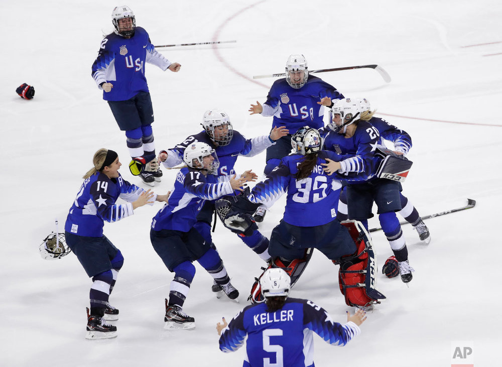 United States celebrates winning gold in the women's gold medal hockey game. 