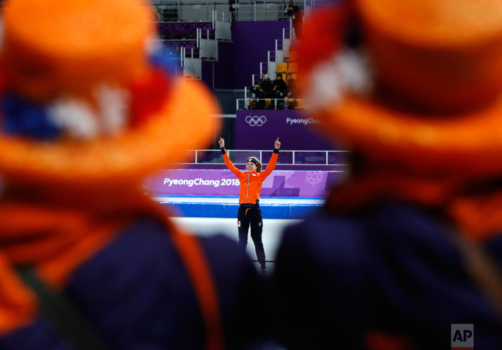  Dutch supporters watch as gold medalist Esmee Visser of The Netherlands celebrates on the podium after the women's 5,000 meters speedskating race at the Gangneung Oval at the 2018 Winter Olympics in Gangneung, South Korea, Friday, Feb. 16, 2018. (AP