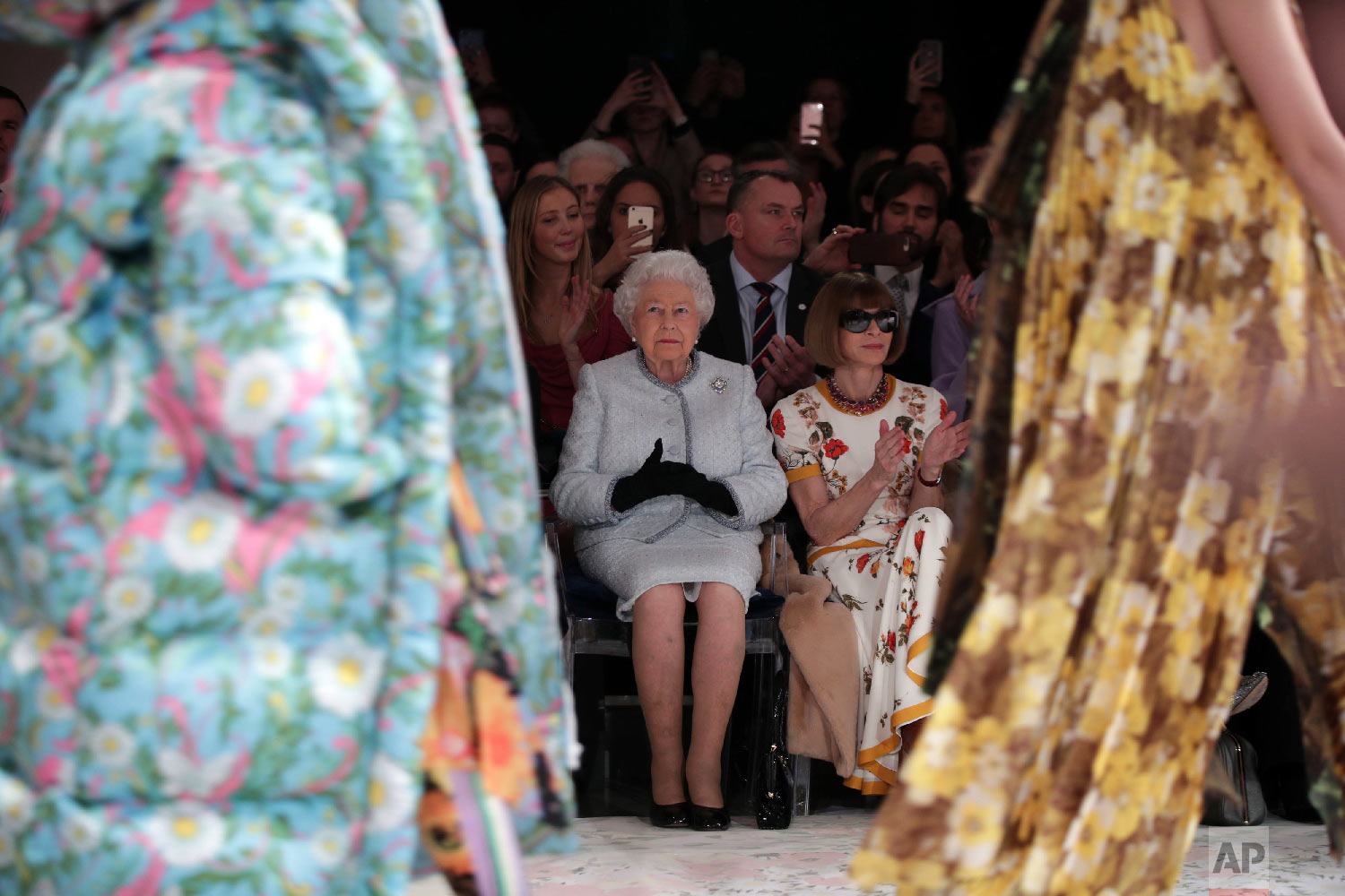  Britain's Queen Elizabeth, center left, sits next to fashion editor Anna Wintour as they view Richard Quinn's runway show before presenting him with the inaugural Queen Elizabeth II Award for British Design, as she visits London Fashion Week's BFC S