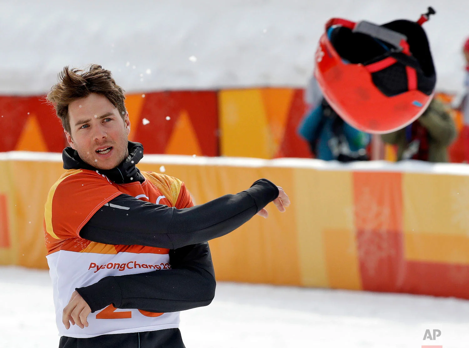 Bronze medal winner Zan Kosir, of Slovenia, tosses his helmet after the men's parallel giant slalom small final at Phoenix Snow Park at the 2018 Winter Olympics in Pyeongchang, South Korea, Saturday, Feb. 24, 2018. (AP Photo/Kin Cheung)