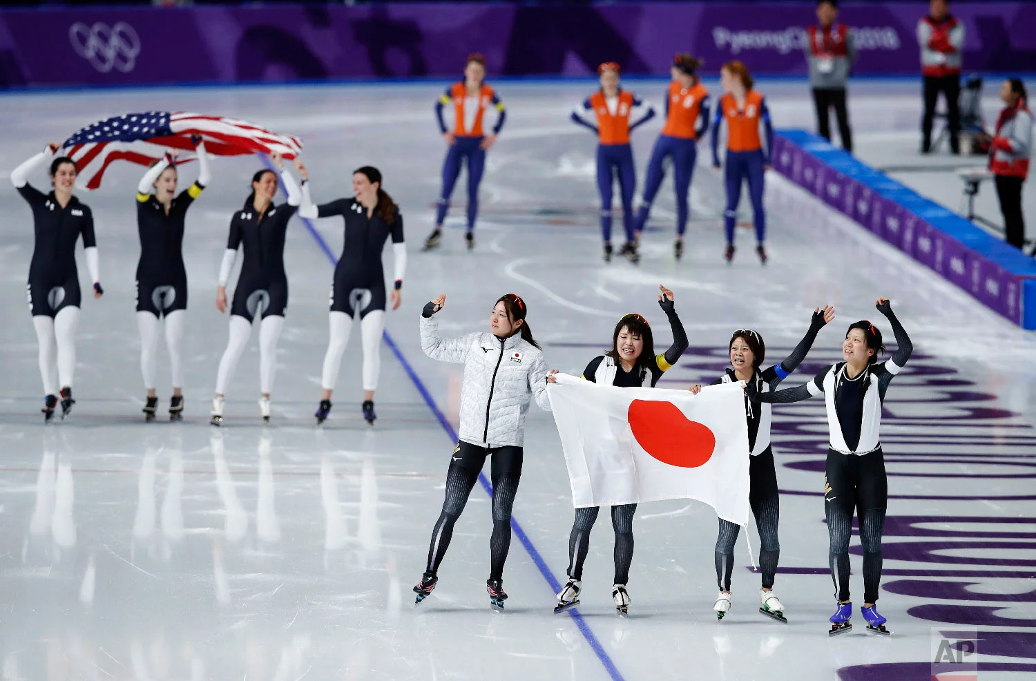 Gold medalist team Japan, front, and bronze medalist team U.S.A. celebrate, while silver medalist team Netherlands appears dejected after the women's team pursuit speedskating race at the Gangneung Oval at the 2018 Winter Olympics in Gangneung, South Korea, Wednesday, Feb. 21, 2018. (AP Photo/Vadim Ghirda)