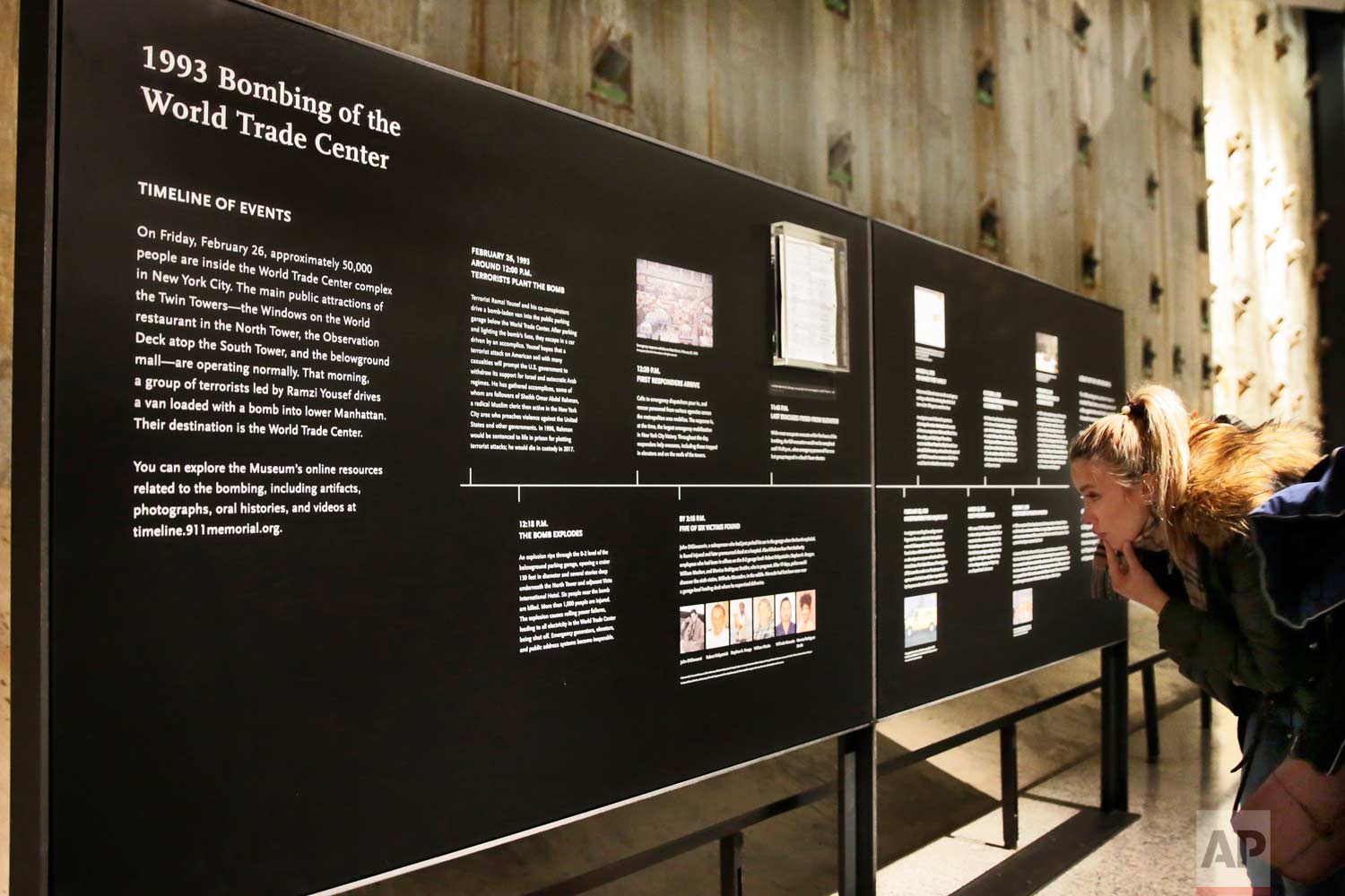  A visitor to the National September 11 Museum, in New York, Friday, Feb. 23, 2018, looks at a timeline of events of the Feb. 26, 1993 truck bomb attack at the World Trade Center. It was a terror attack that foreshadowed Sept. 11: the deadly World Tr