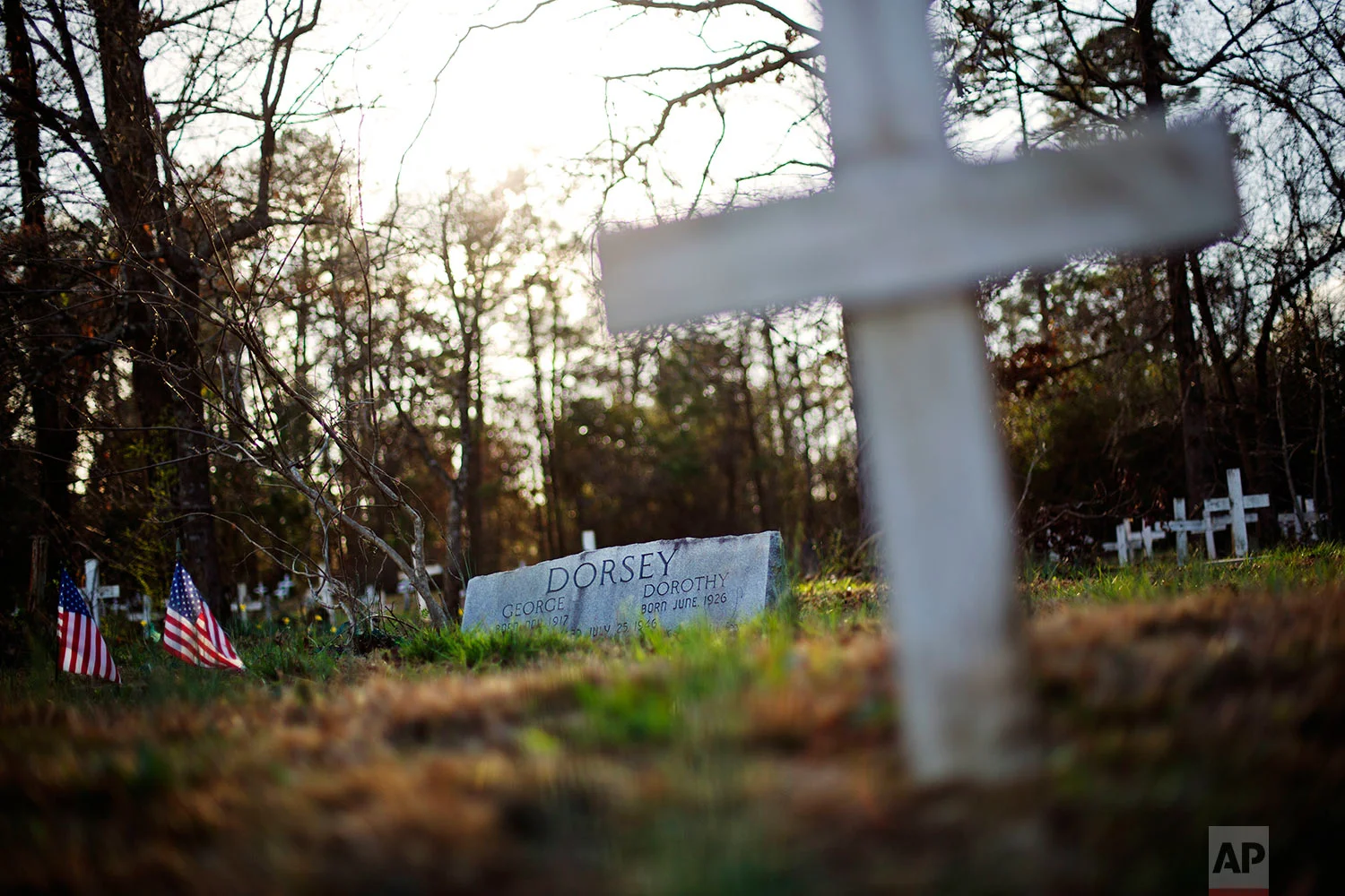 A tombstone marks the grave of George Dorsey and his sister, Dorothy Malcom who in 1946 were stopped by a white mob who dragged them to a riverbank and shot them multiple times, in Bishop, Ga., Thursday, Feb. 22, 2018. (AP Photo/David Goldman)