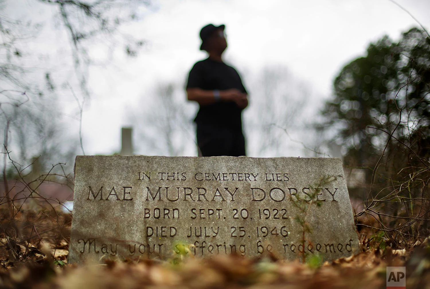 Tyrone Brooks, a veteran civil rights activist, stands behind the tombstone of Mae Murray Dorsey who was killed in a 1946 lynching by a white mob in Monroe, Ga., Thursday, Feb. 22, 2018. (AP Photo/David Goldman)