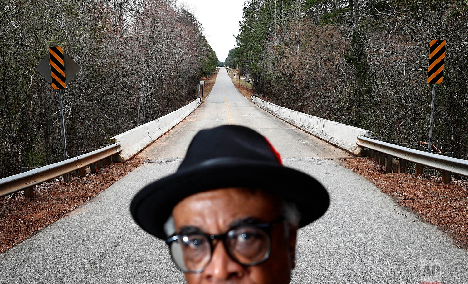 In this Feb. 22, 2018 photo, Tyrone Brooks, a veteran civil rights activist, stands near the spot along the rural Moore's Ford Road where in 1946 two young black couples were stopped by a white mob and shot multiple times in Monroe, Ga. Even if no one is ultimately prosecuted for the deaths of Roger and Dorothy Malcom and George and Mae Murray Dorsey, it's important to know what happened and who was involved, said Brooks. Nonetheless, he said the closure of the investigations won't stop him. "Our resolve is as strong as it's ever been," Brooks said. (AP Photo/David Goldman)
