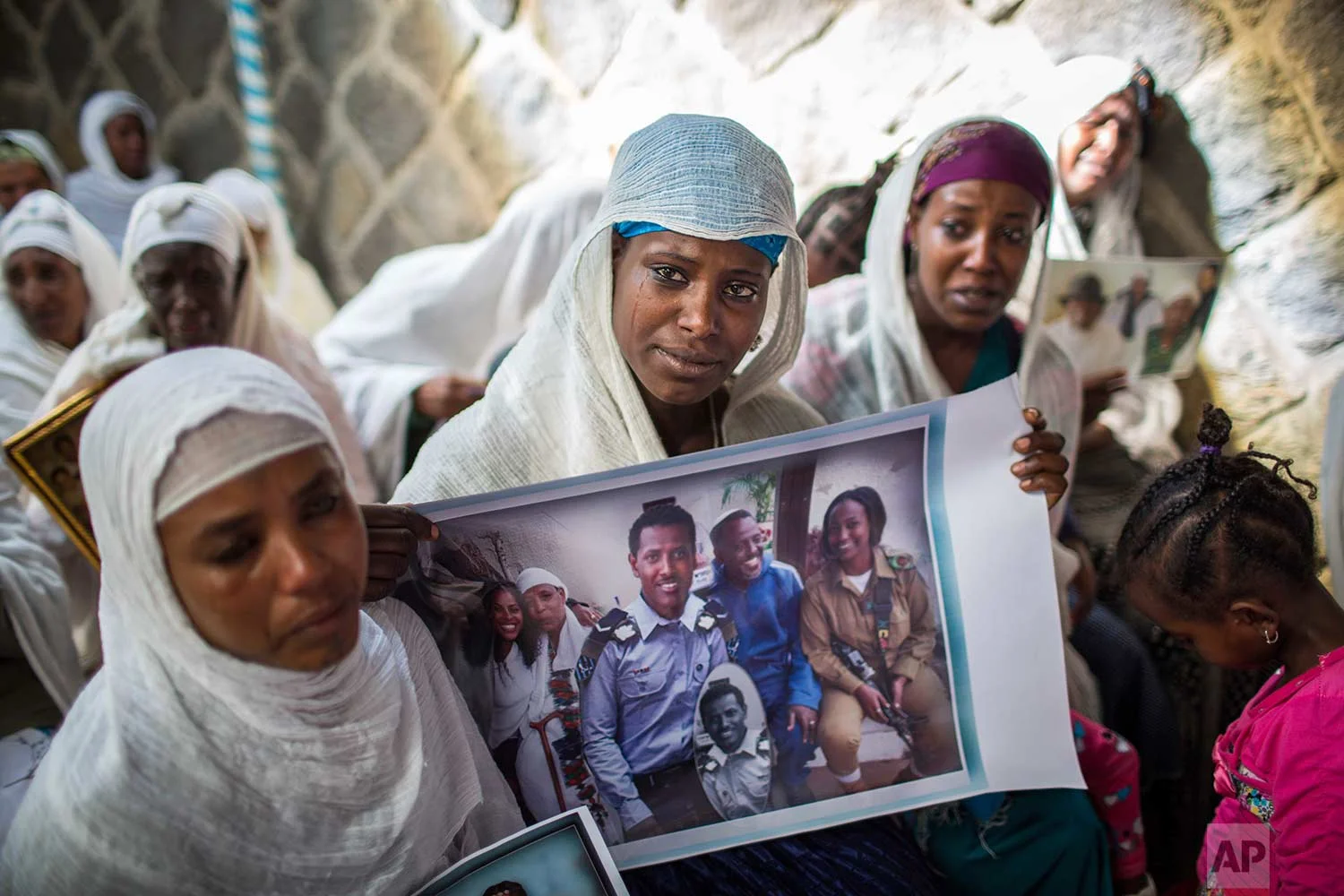 Members of Ethiopia's Jewish community hold pictures of their relatives in Israel, during a solidarity event at the synagogue in Addis Ababa, Ethiopia Wednesday, Feb. 28, 2018. (AP Photo/Mulugeta Ayene)