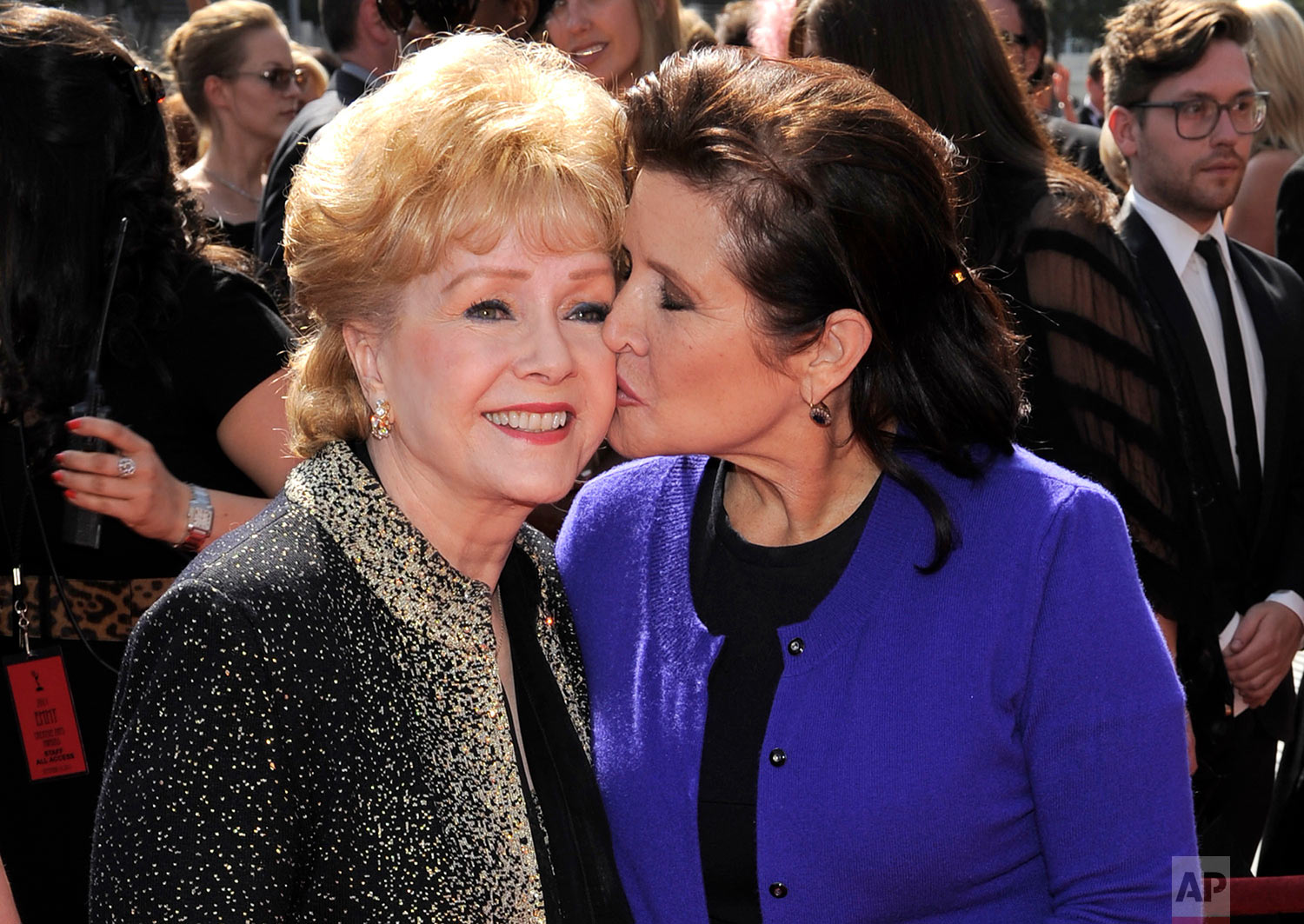  FILE- In this Sept. 10, 2011, file photo, Debbie Reynolds, left, and Carrie Fisher arrive at the Primetime Creative Arts Emmy Awards in Los Angeles. Reynolds, star of the 1952 classic "Singin' in the Rain" died Wednesday, Dec. 28, 2016, according to