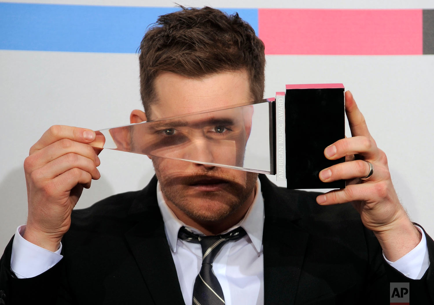  Michael Buble poses with the award for adult contemporary music favorite artist backstage at the 38th Annual American Music Awards on Sunday, Nov. 21, 2010 in Los Angeles. (AP Photo/Chris Pizzello) 