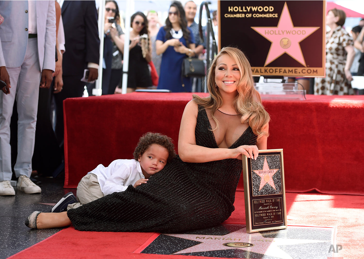  Mariah Carey, right, and her son Moroccan Cannon pose during a ceremony honoring Carey with a star on the Hollywood Walk of Fame on Wednesday, Aug. 5, 2015 in Los Angeles.  (Photo by Chris Pizzello/Invision/AP) 