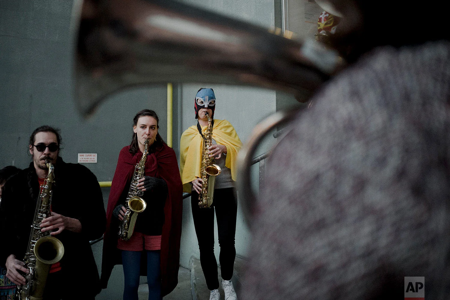  In this photo dated Saturday, Feb. 24, 2018 musicians perform during a wrestling charity gala in Ivry-sur-Seine, south of Paris, France. (AP Photo/Kamil Zihnioglu) 