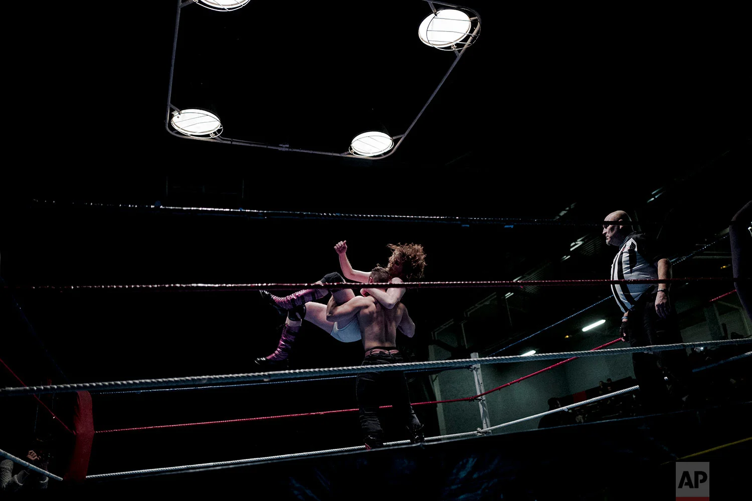  In this photo dated Saturday, Feb. 24, 2018, wrestler Lord Steven Crowley, top, jumps on Zack during a wrestling charity gala in Ivry-sur-Seine, south of Paris, France. (AP Photo/Kamil Zihnioglu) 