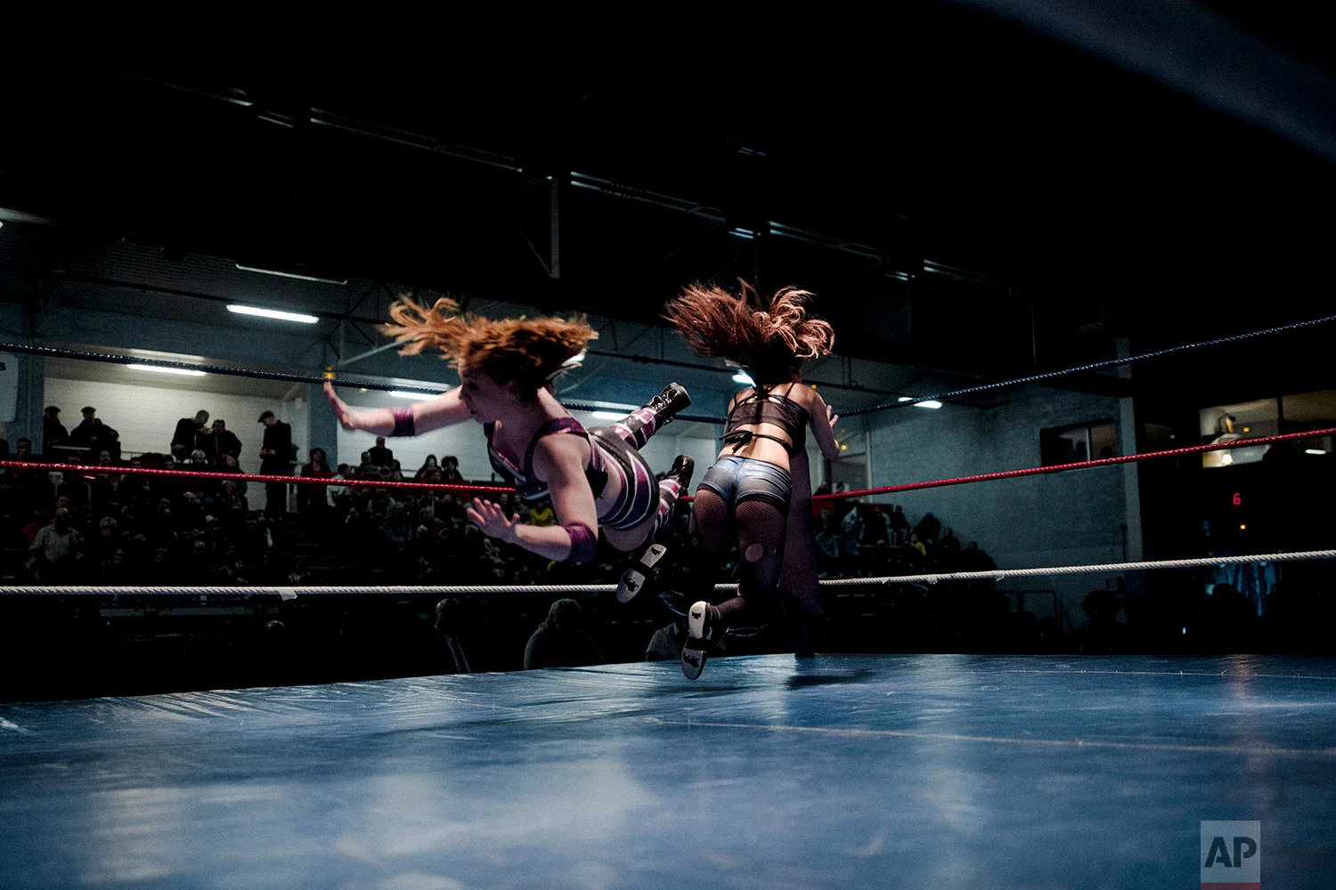  In this photo dated Saturday, Feb. 24, 2018, wrestler Camille, left, fights with Delia during a wrestling charity gala in Ivry-sur-Seine, south of Paris, France. (AP Photo/Kamil Zihnioglu) 