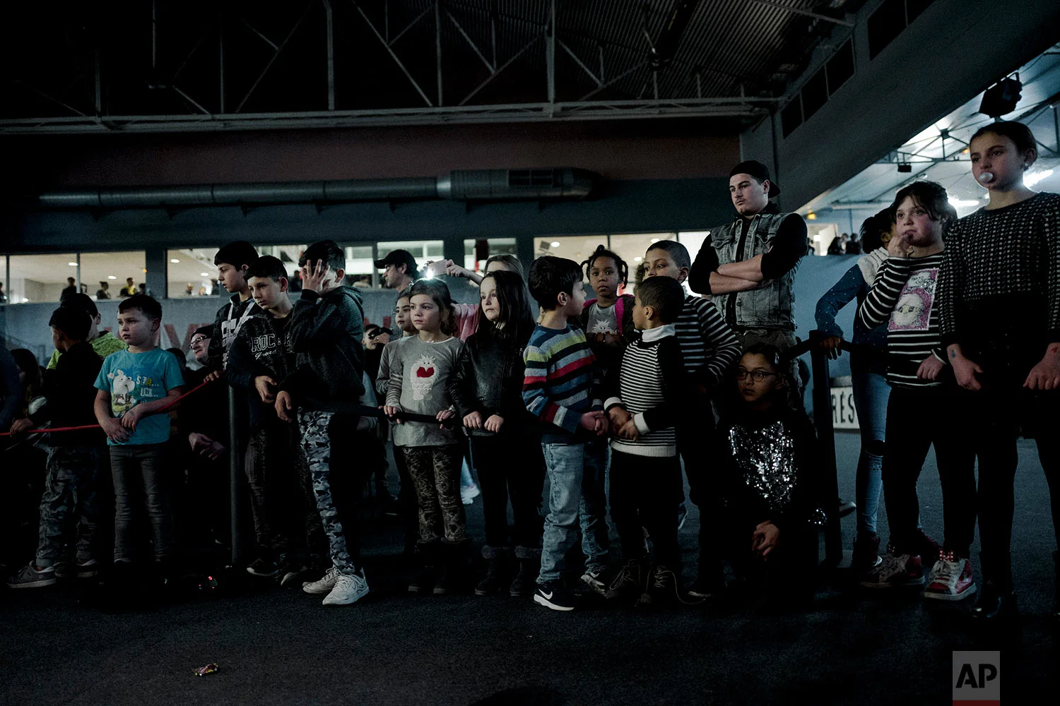  In this photo dated Saturday, Feb. 24, 2018, children watch a fight during a wrestling charity gala in Ivry-sur-Seine, south of Paris, France. (AP Photo/Kamil Zihnioglu) 