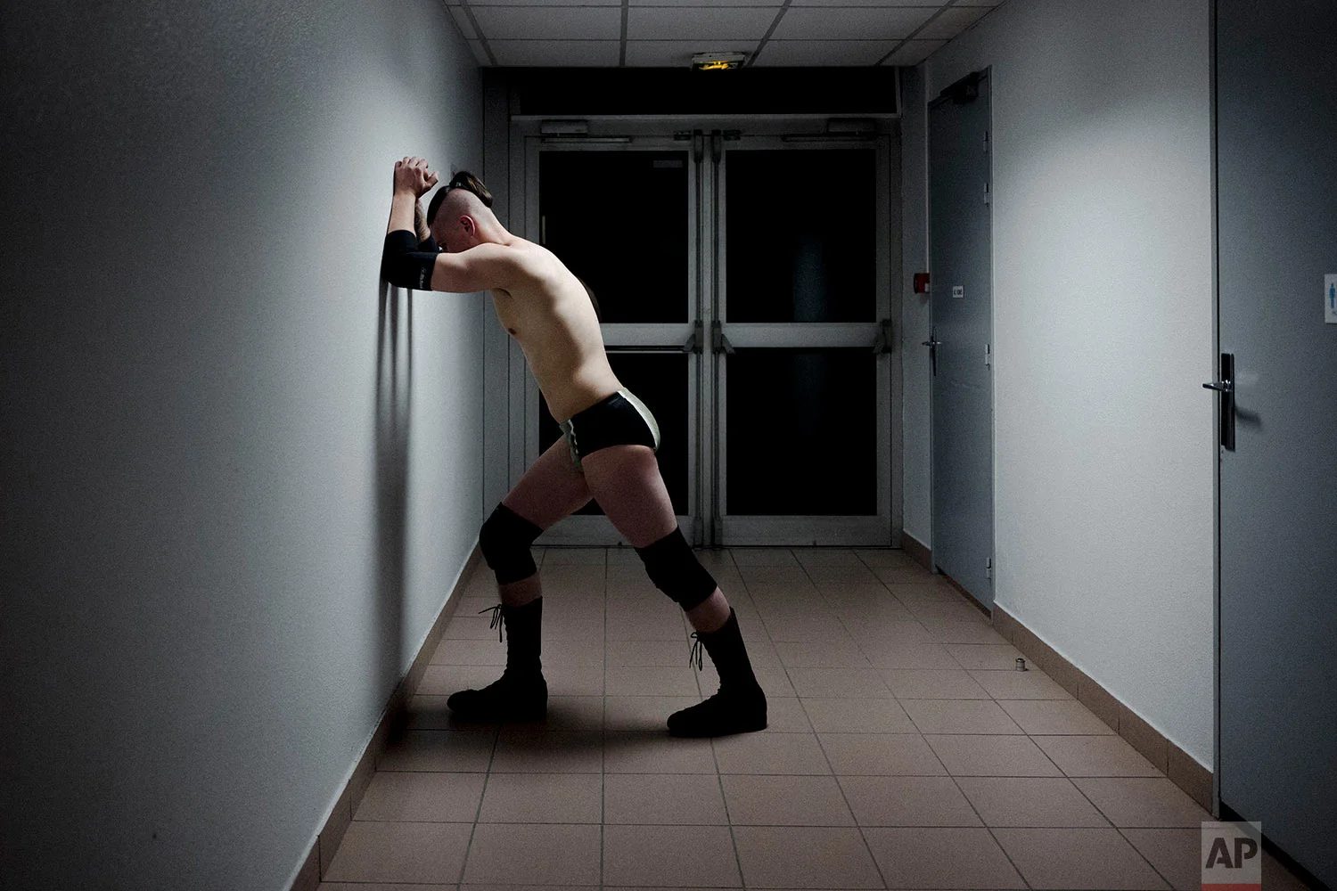  In this photo dated Saturday, Feb. 24, 2018, wrestler Alex Legrand warms up just before climbing onto the ring during a wrestling charity gala in Ivry-sur-Seine, south of Paris, France.  (AP Photo/Kamil Zihnioglu) 