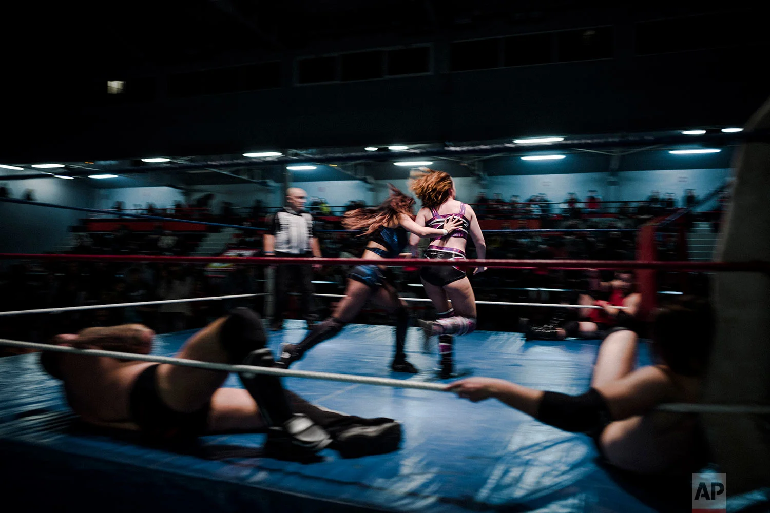  In this photo dated Saturday, Feb. 24, 2018, wrestlers Delia, center left, and Camille fight during a wrestling charity gala in Ivry-sur-Seine, south of Paris, France.  (AP Photo/Kamil Zihnioglu) 