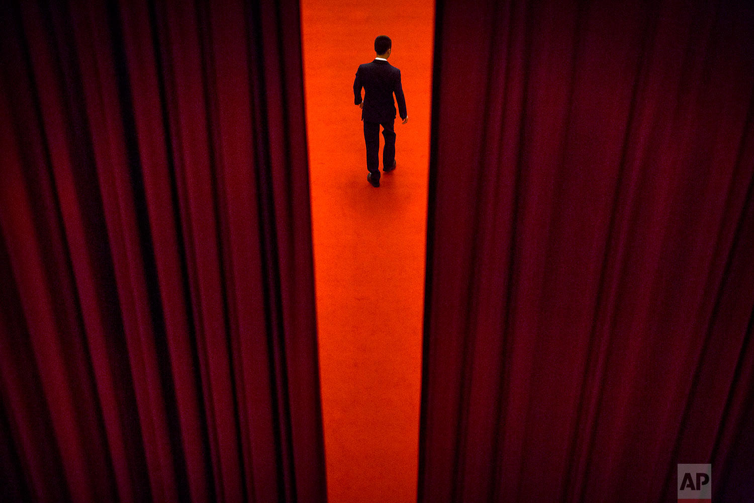  In this Thursday, March 8, 2018 photo, a security official walks through a curtained-off area during a plenary session of the Chinese People's Political Consultative Conference (CPPCC) at the Great Hall of the People in Beijing.  (AP Photo/Mark Schi