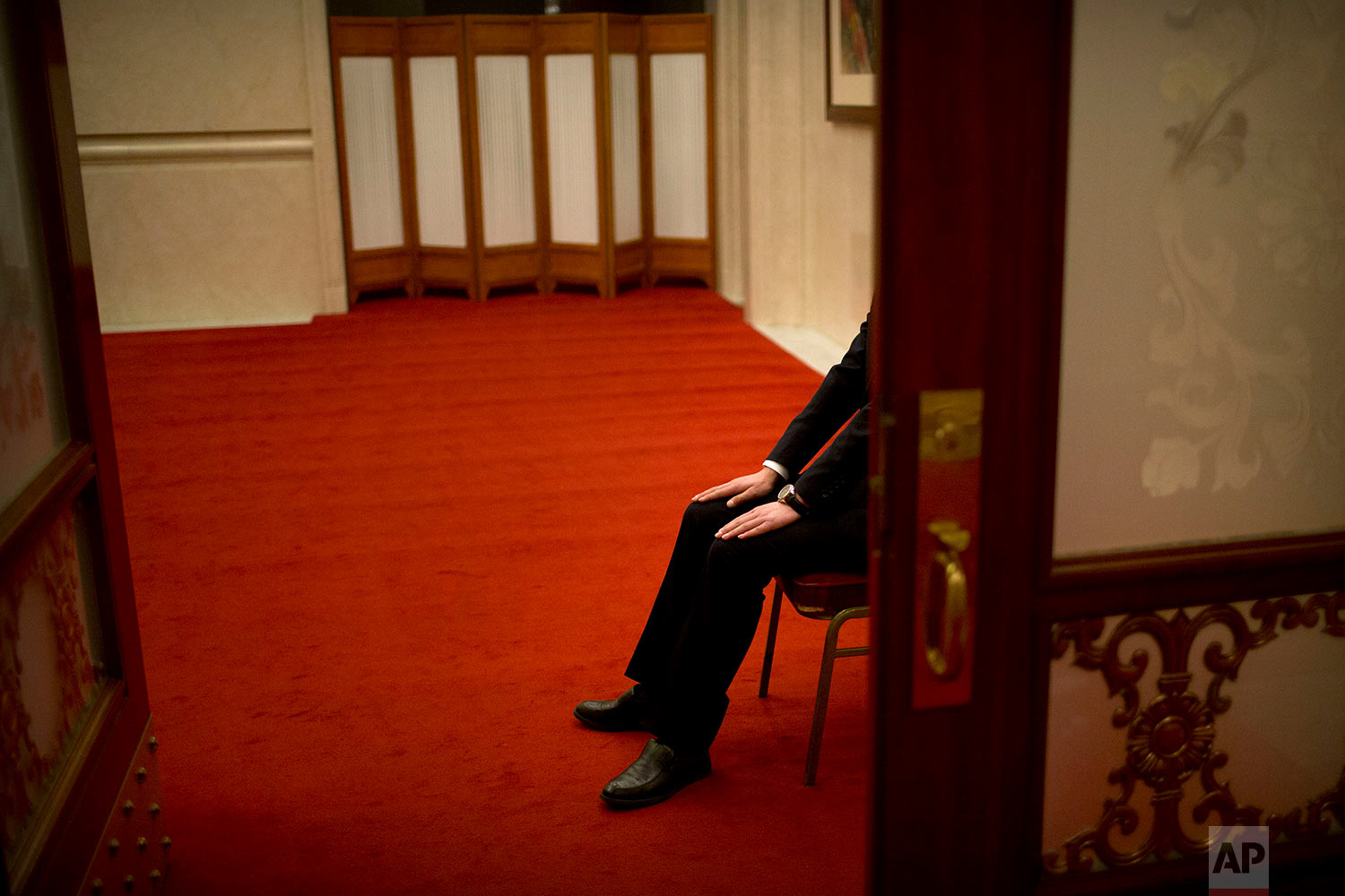  In this Tuesday, March 6, 2018 photo, a security official sits in a chair at a doorway at the Great Hall of the People in Beijing. (AP Photo/Mark Schiefelbein) 