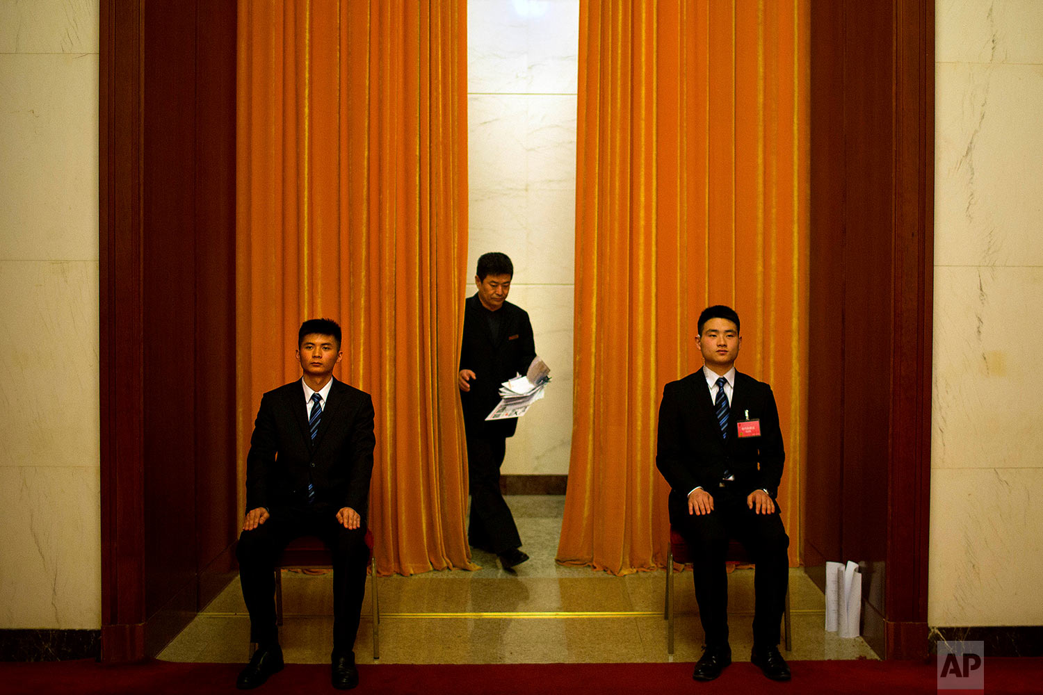  In this Tuesday, March 6, 2018 photo, an official walks out from behind a curtained-off area at the Great Hall of the People in Beijing. (AP Photo/Mark Schiefelbein) 