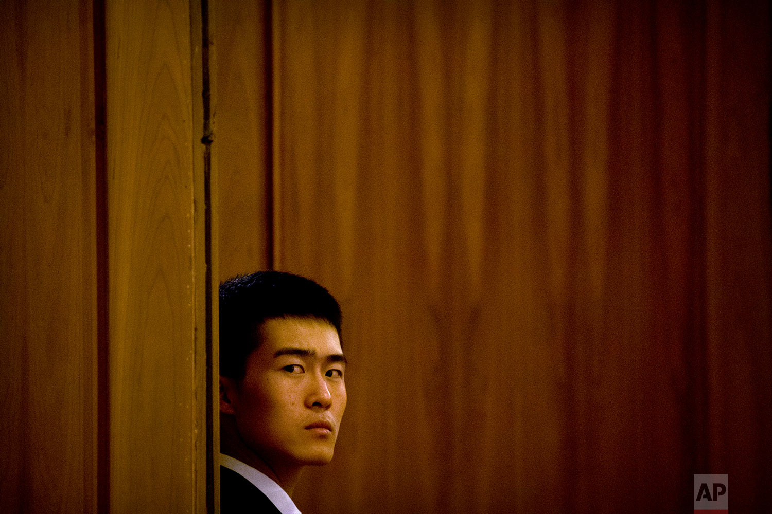  In this Friday, March 9, 2018 photo, a security official stands guard at a door during a plenary session of China's National People's Congress (NPC) at the Great Hall of the People in Beijing. (AP Photo/Mark Schiefelbein) 
