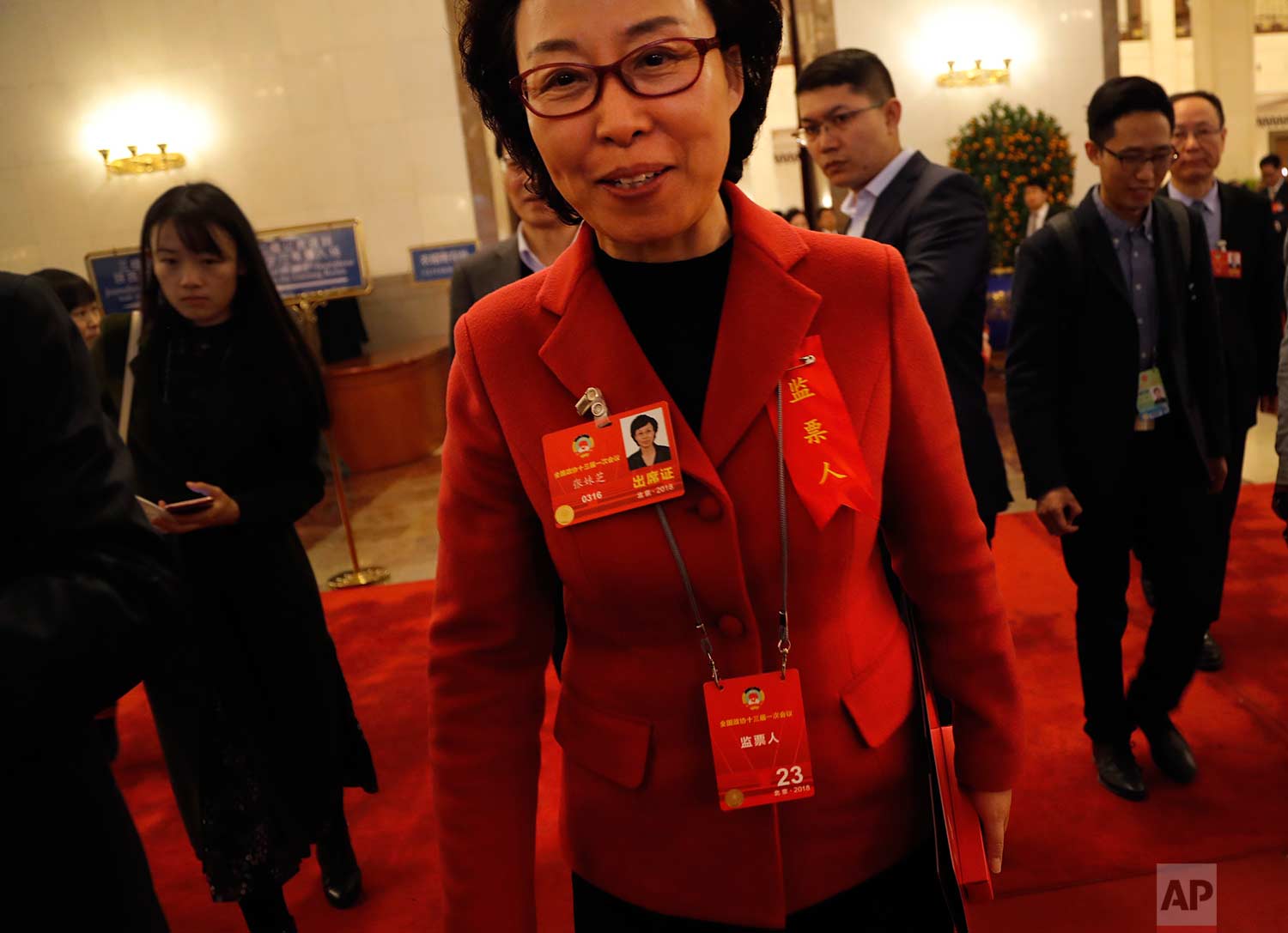  In this Wednesday, March 14, 2018 photo, a delegate in red jacket leaves after attending a plenary session of Chinese People's Political Consultative Conference (CPPCC) at the Great Hall of the People in Beijing. (AP Photo/Aijaz Rahi) 