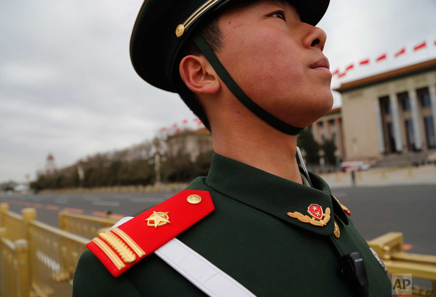  In this Thursday, March 15, 2018 photo, a Chinese paramilitary policeman wears a red epaulette on his shoulder as he stands guard during the closing session of the Chinese People's Political Consultative Conference (CPPCC) at the Great Hall of the P