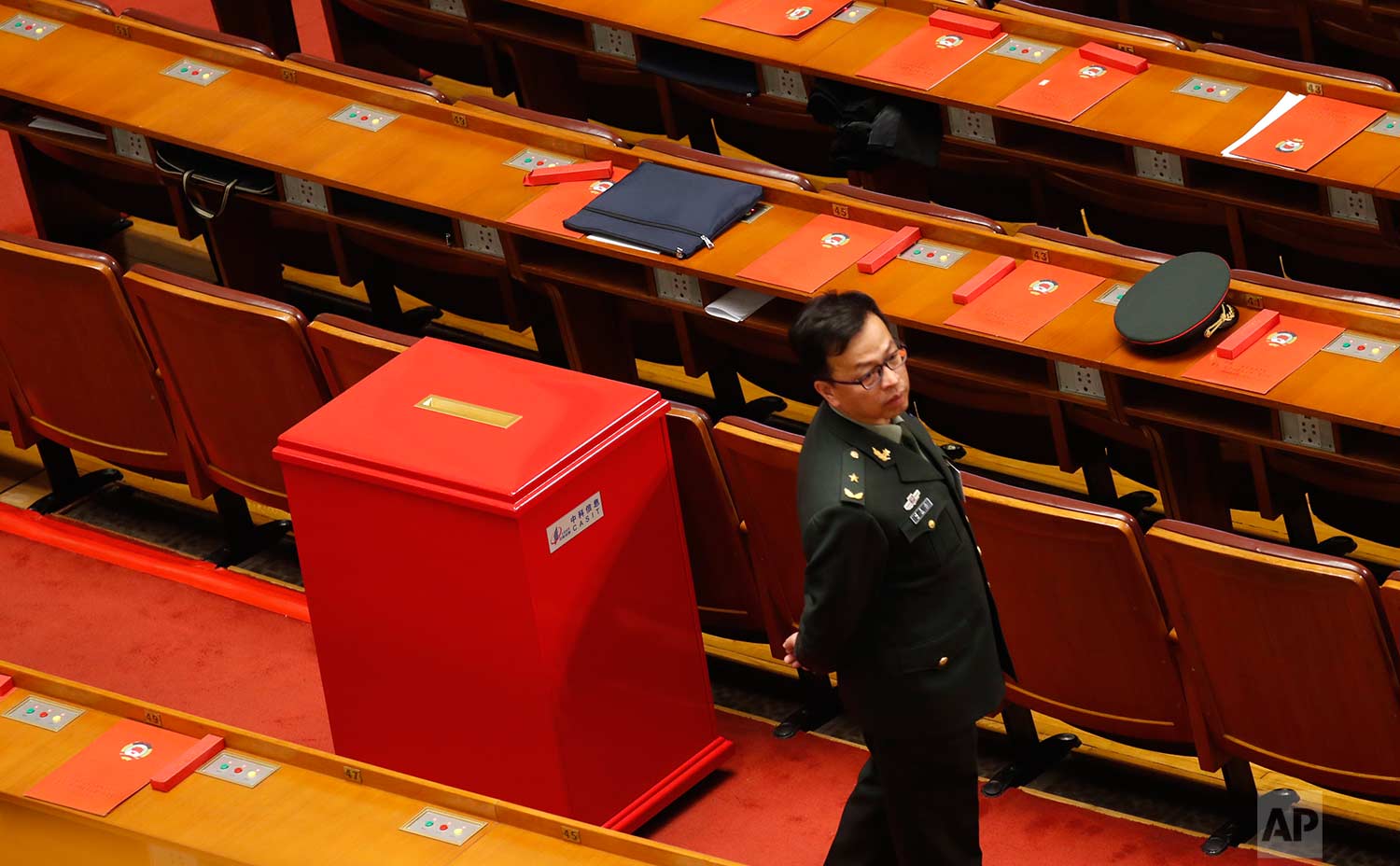  In this Wednesday, March 14, 2018 photo, a military delegate stands next to red ballot box during a plenary session of Chinese People's Political Consultative Conference (CPPCC) at the Great Hall of the People in Beijing, Wednesday, March 14, 2018. 