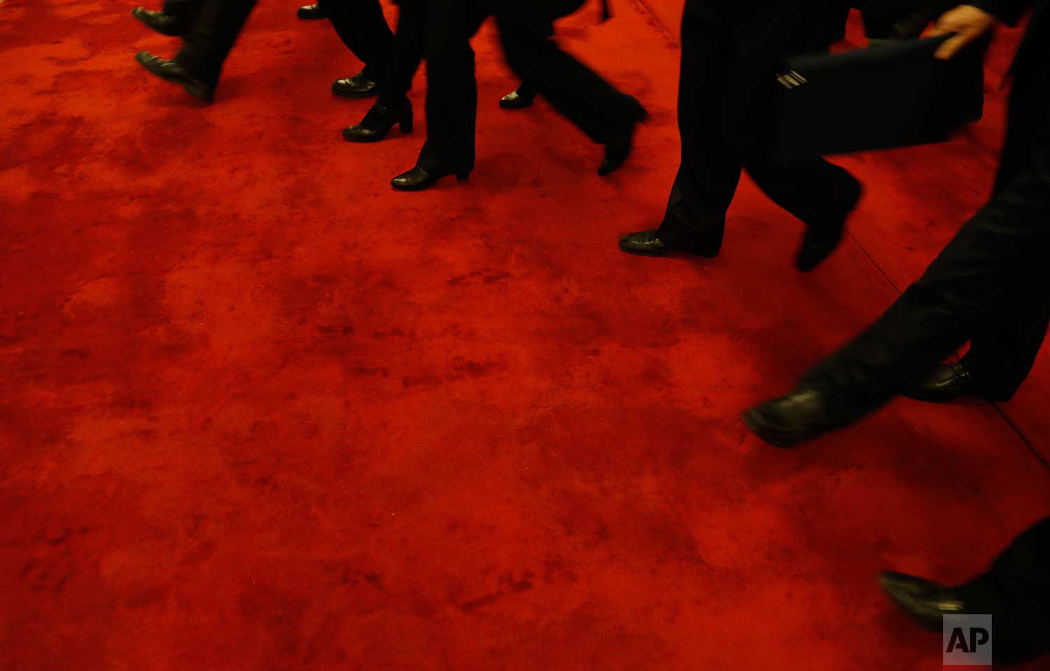  In this Wednesday, March 14, 2018 photo, delegates walk on a red carpet as they leave after attending a plenary session of Chinese People's Political Consultative Conference (CPPCC) at the Great Hall of the People in Beijing. (AP Photo/Aijaz Rahi) 