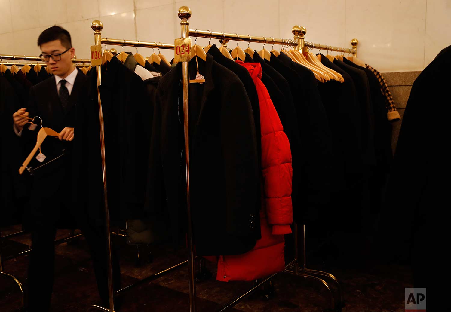  In this Tuesday, March 13, 2018 photo, a red jacket hangs amid black coats before the start during a plenary session of China's National People's Congress (NPC) at the Great Hall of People in Beijing. (AP Photo/Aijaz Rahi) 