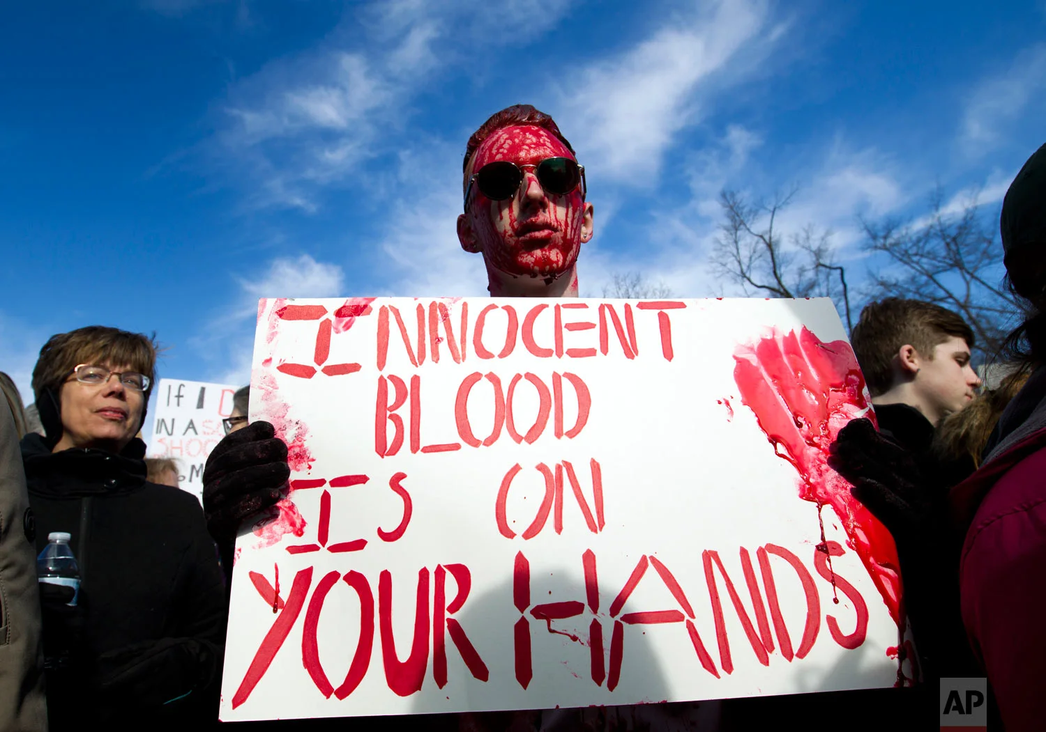 Connor Feliu of Syracuse N.Y., covered in red paint, attends the "March for Our Lives" rally in support of gun control in Washington, Saturday, March 24, 2018, on Pennsylvania Avenue near the U.S. Capitol. (AP Photo/Jose Luis Magana)