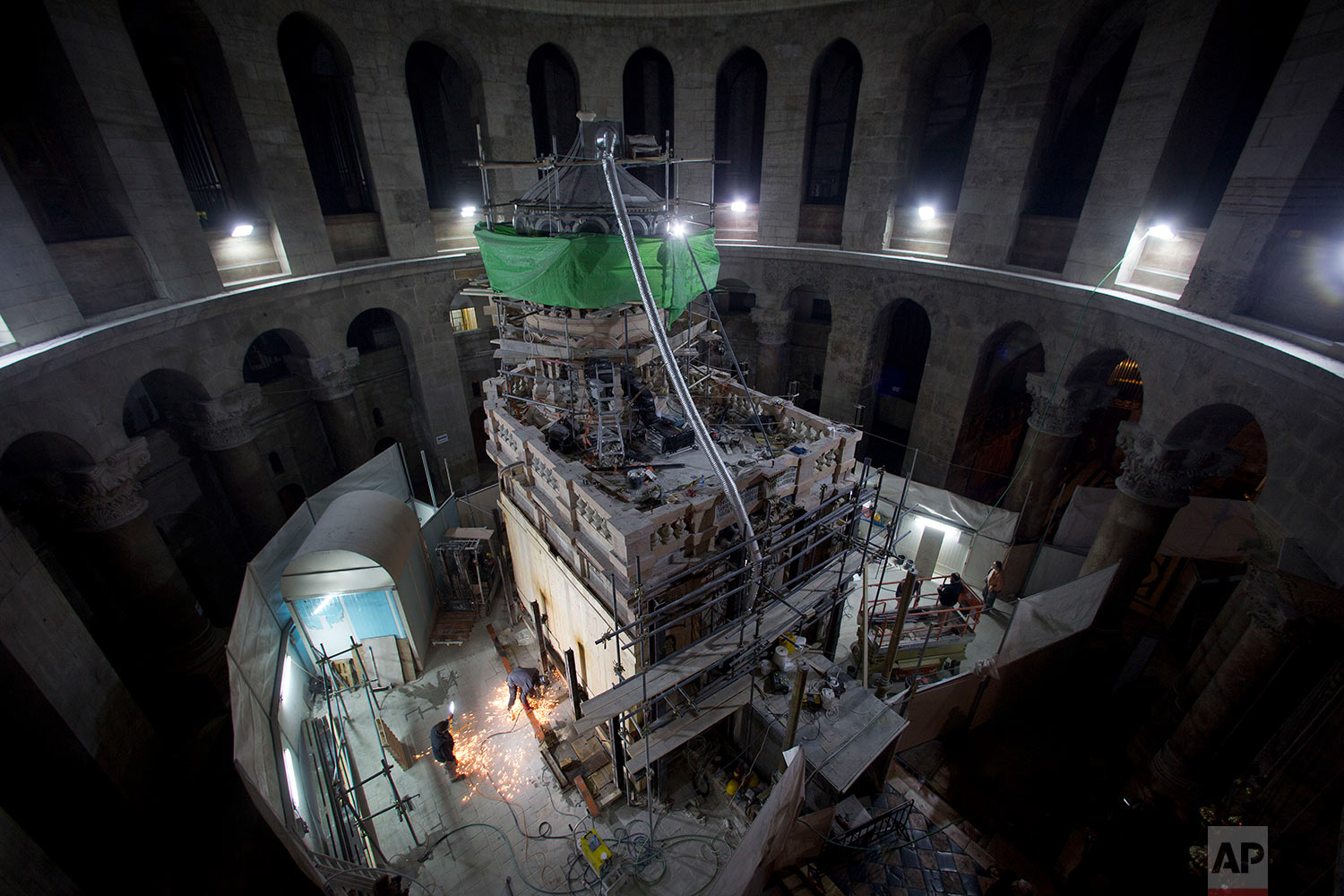 Members of the conservation team remove steel girders supporting the Edicule during restoration work, at the Church of the Holy Sepulchre in Jerusalem's Old City Wednesday, Feb. 22, 2017. (AP Photo/Oded Balilty) 