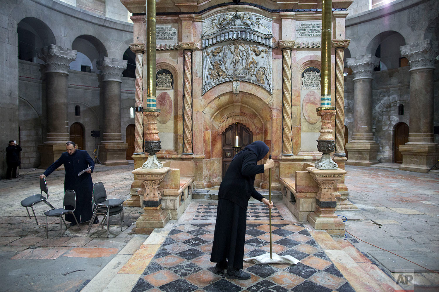  A nun cleans the area around the  renovated Edicule ahed of a ceremony marking the completion of the renovation in the Church of the Holy Sepulchre, in Jerusalem's Old City, Wednesday, March 22, 2017. (AP Photo/Oded Balilty) 