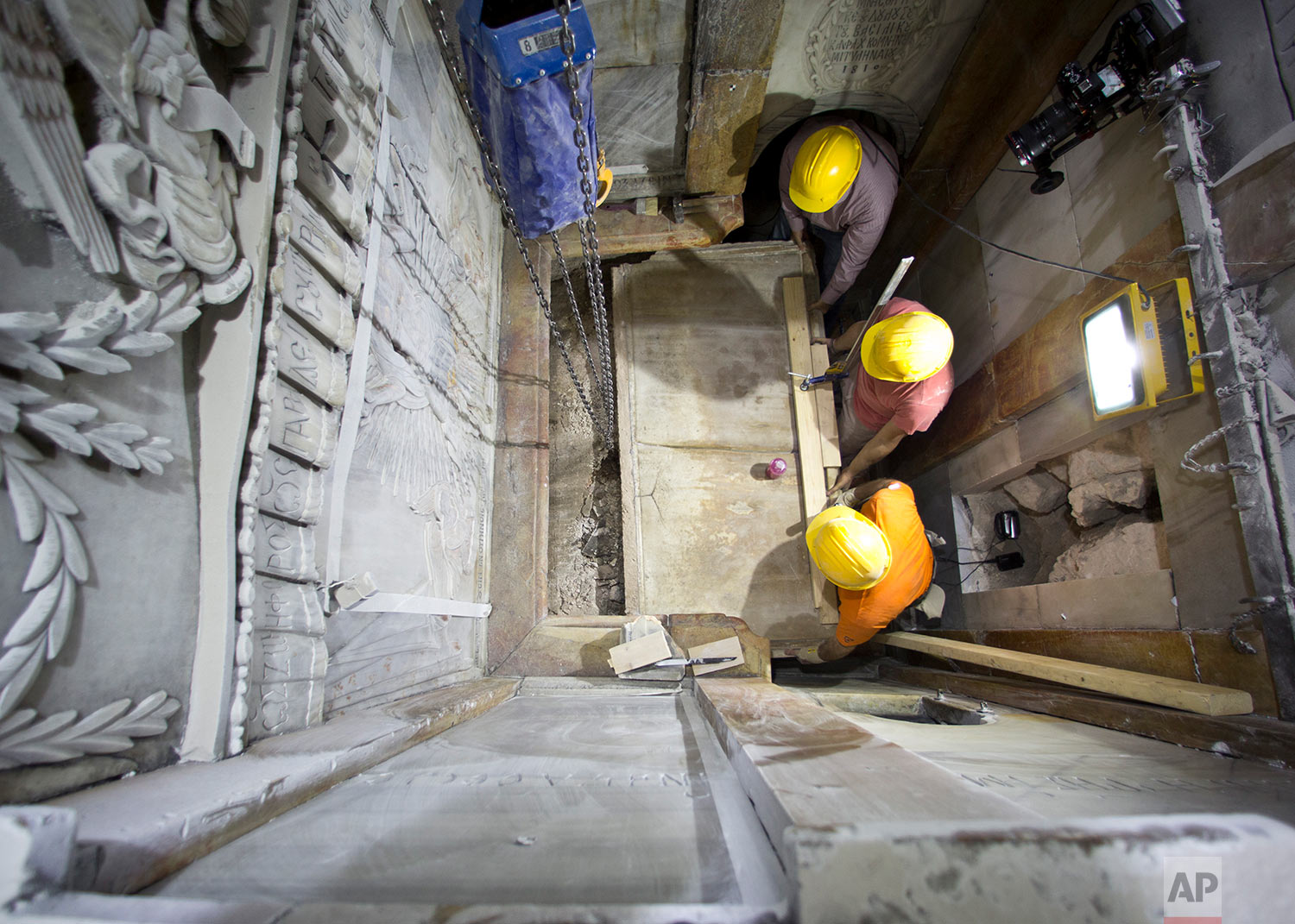  In this Wednesday Oct. 26, 2016 photo, workers remove the top of what is considered the burial place of Jesus in the Church of Holy Sepulchre in Jerusalem. The tomb was opened for the first time in centuries in October 2016, when the shrine that enc